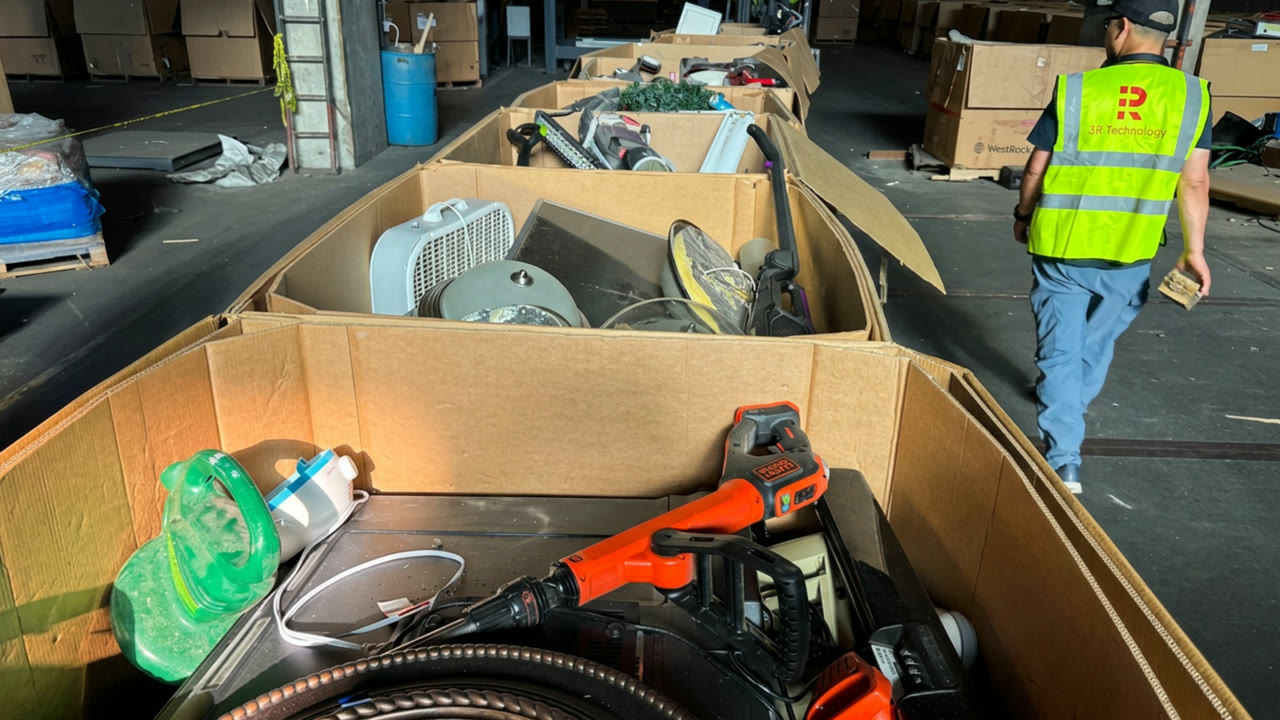 A row of bins filled with mixed e-waste ready for sorting